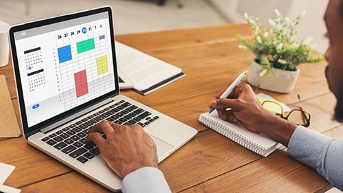 person using a laptop to schedule an online appointment